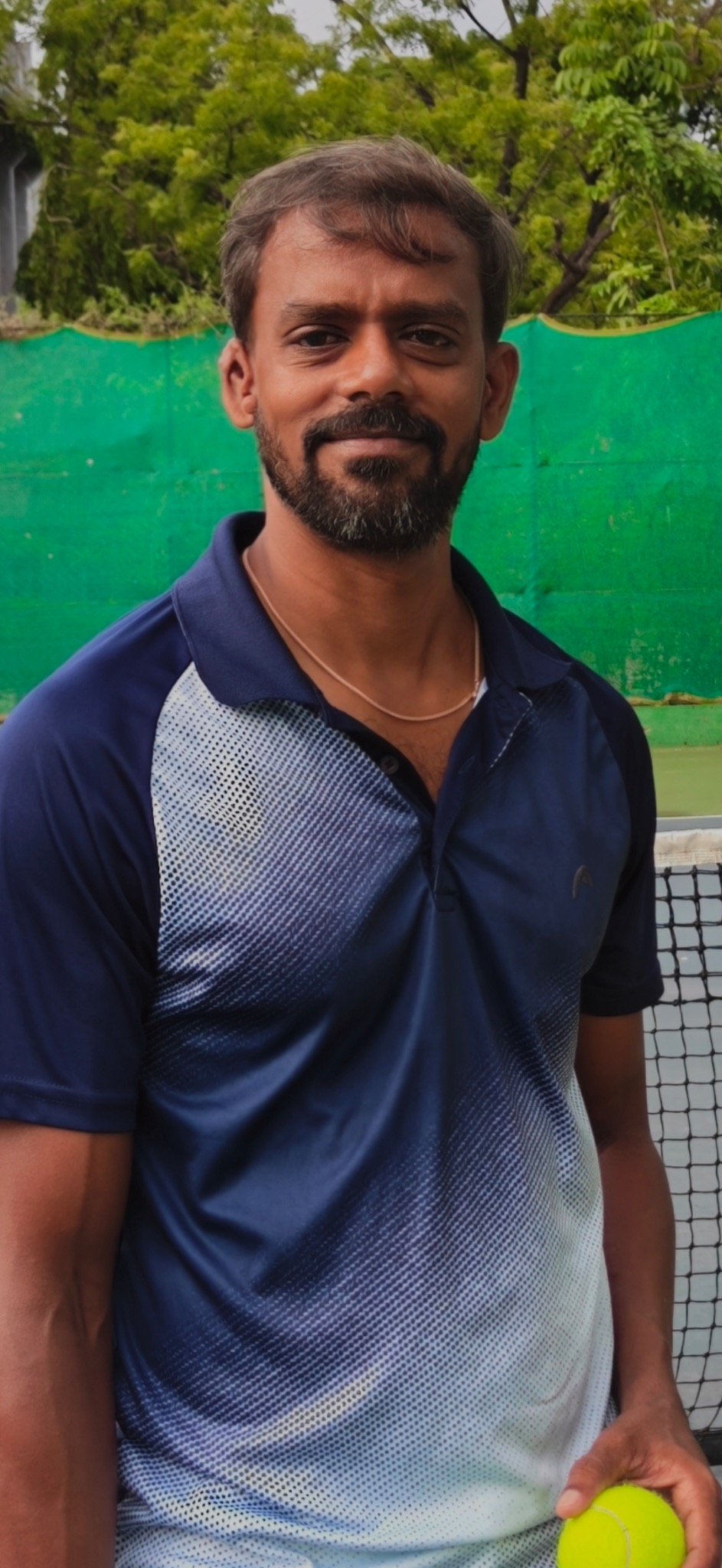 Mohan on a tennis court